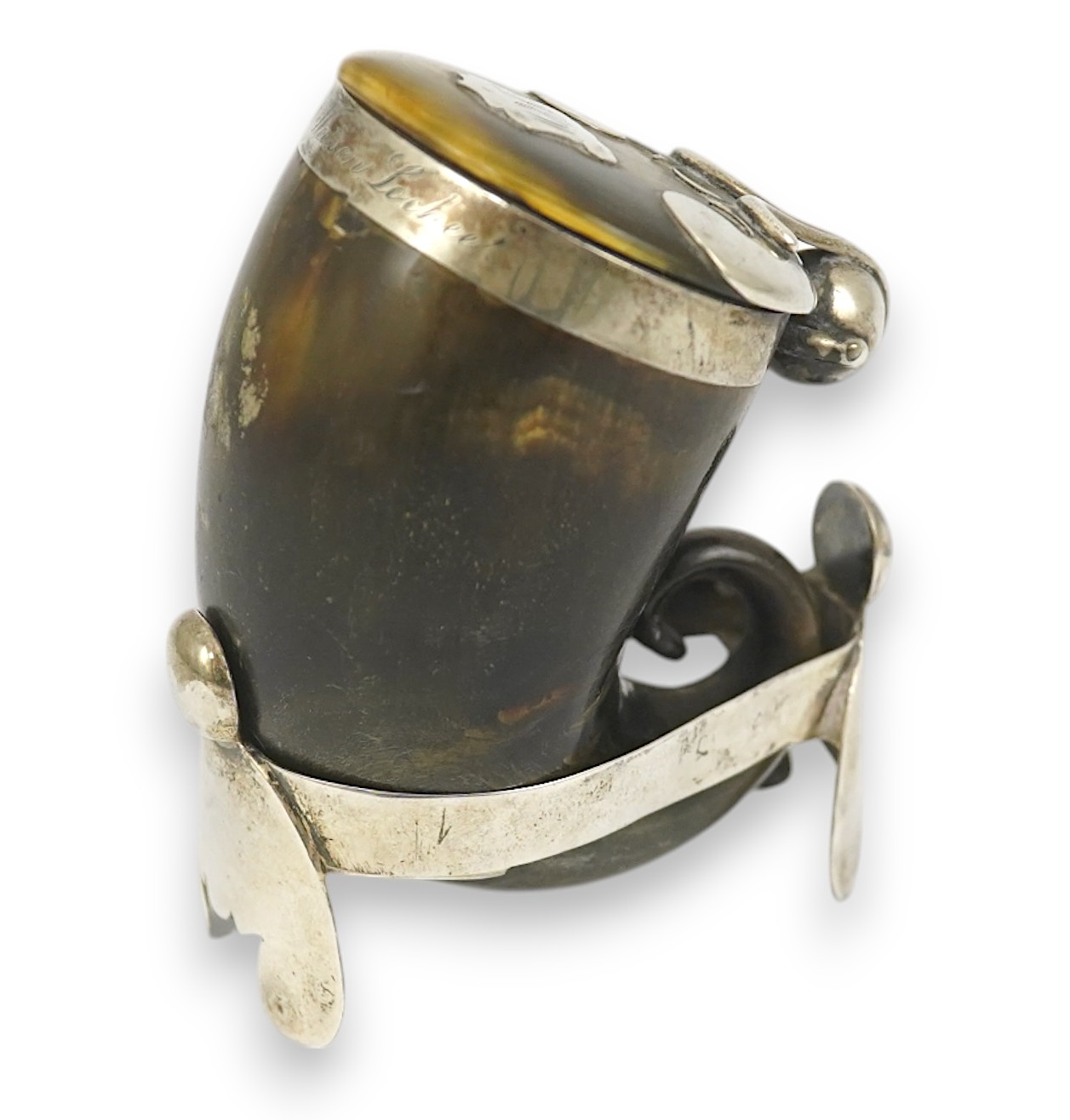 A 19th century Scottish silver mounted horn snuff mull, 7cm, on a silver stand.